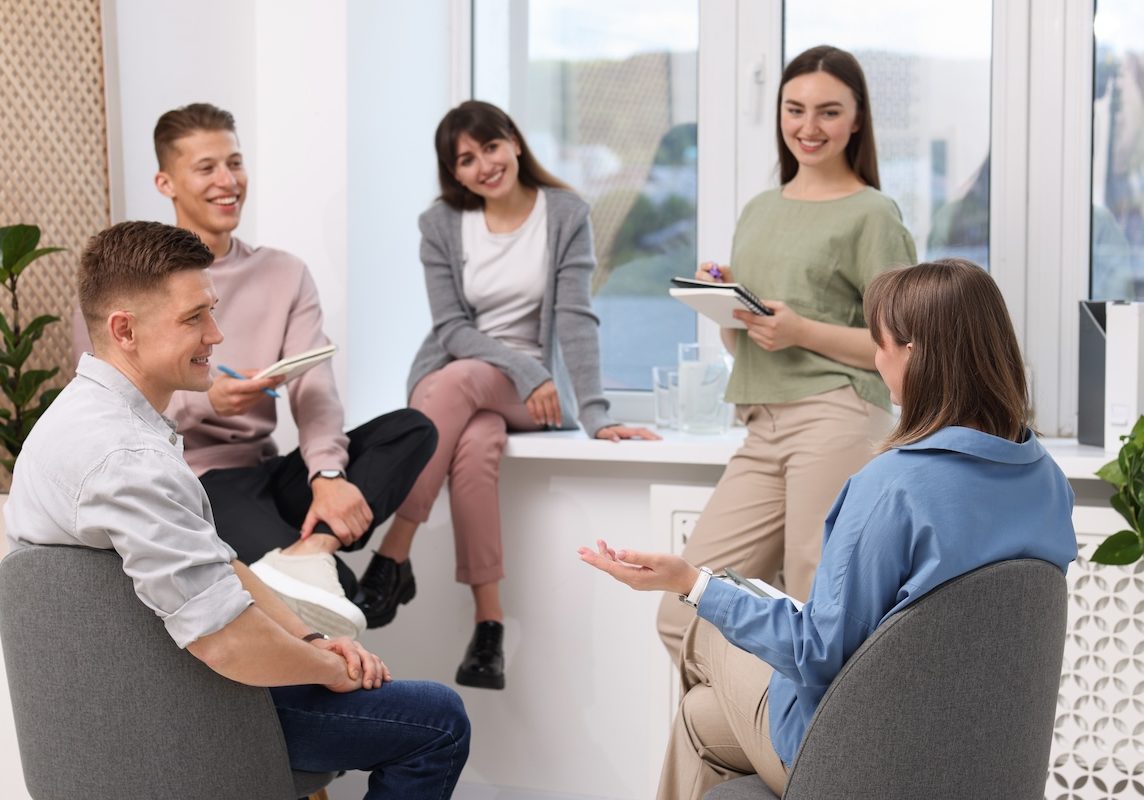 Group of people having meeting during life coaching class indoors